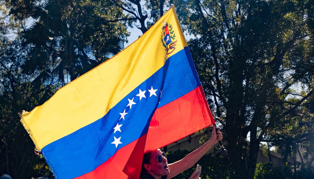A woman waves Venezuela's flag out her sunroof in celebration after news of Venezuelan President Nicolás Maduro being captured and flown out of the country, in Doral, Fla., Jan. 3, 2026. (AP)