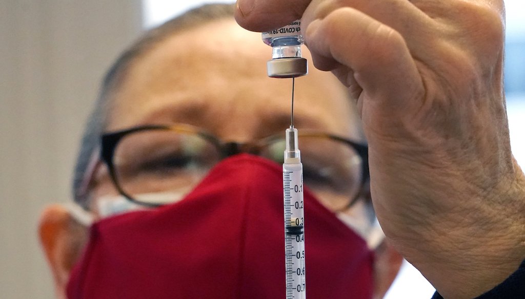 Healthcare volunteer Melissa Lowry prepares a COVID-19 vaccine at a regional vaccination site in Massachusetts. (AP Photo/Elise Amendola)