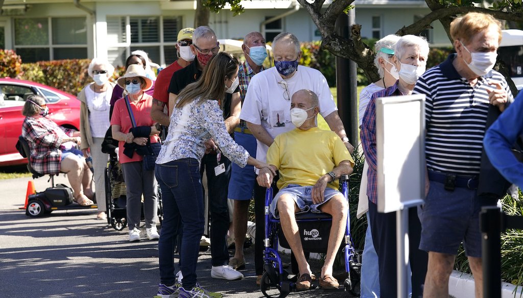 Robert Birkenmeier, center, waits in line with other residents to receive the Pfizer-BioNTech COVID-19 vaccine, Tuesday, Jan. 19, 2021, at John Knox Village in Pompano Beach, Fla. (AP)