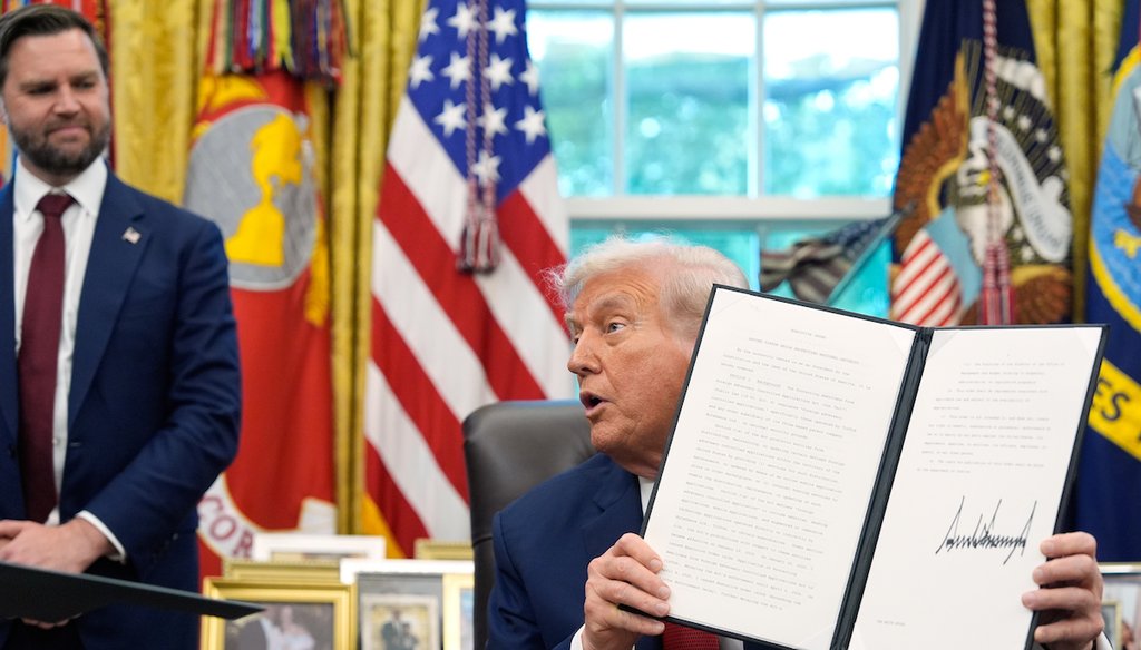 President Donald Trump holds a signed executive order regarding TikTok in the Oval Office at the White House, Thursday, Sept. 25, 2025, in Washington, as Vice President JD Vance watches. (AP_)