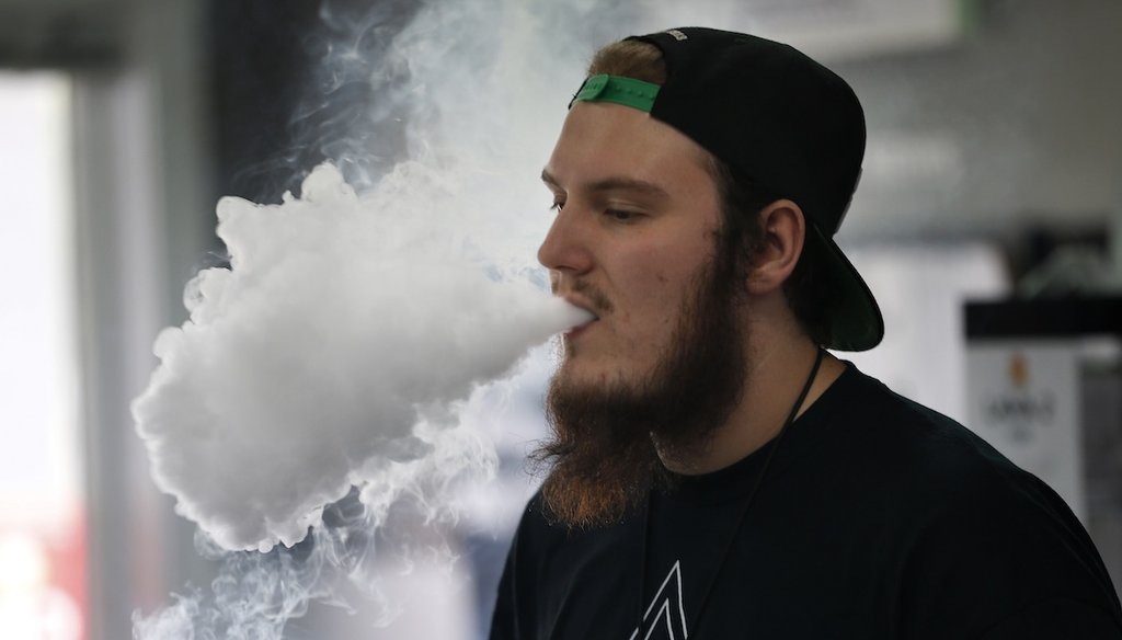 Devin Lambert, the manager at Good Guys Vape Shop, blows out vaping aerosol while using an e-cigarette in Biddeford, Maine, on Sept. 3, 2019. (AP)