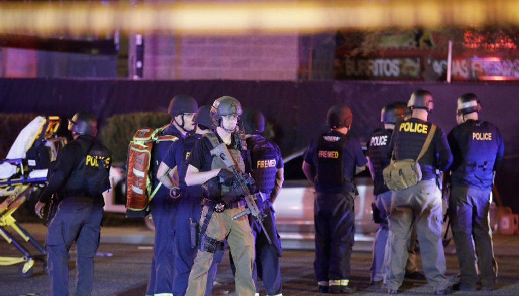 Police officers and medical personnel stand at the scene of a shooting near the Mandalay Bay resort and casino on the Las Vegas Strip, Monday, Oct. 2, 2017, in Las Vegas. Multiple victims were being sent to hospitals after a shooting Sunday. AP photo.