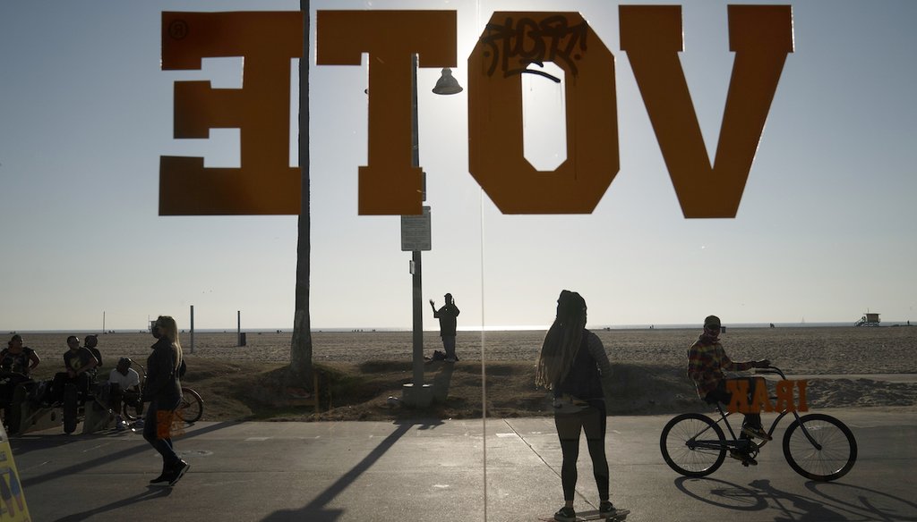 FILE - In this Oct. 28, 2020, file photo, a vote sign is posted on the window of a shoe store on the Venice Beach Boardwalk in Los Angeles. (AP)
