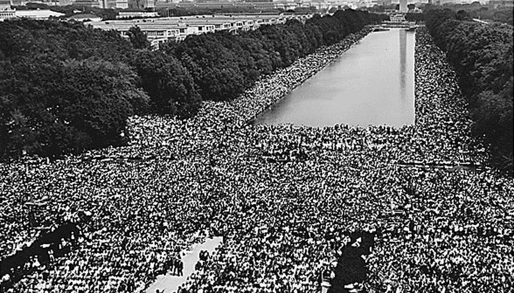 A crowd near the Reflecting Pool listens to Martin Luther King Jr. and other speakers during the March on Washington in 1963. (National Archives/Public domain)