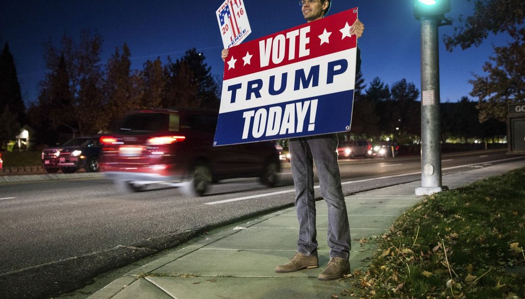 As the polls close, a supporter holds a sign for Donald Trump in Reno, Nev., Nov. 8, 2016. (NY Times)