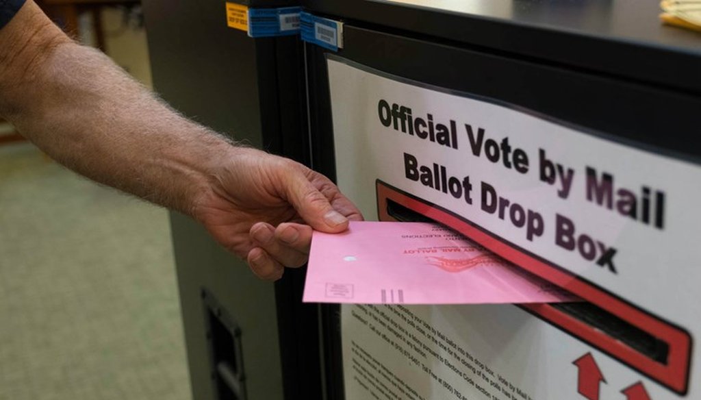 A voter returns a vote by mail ballot in California. Andrew Nixon / CapRadio