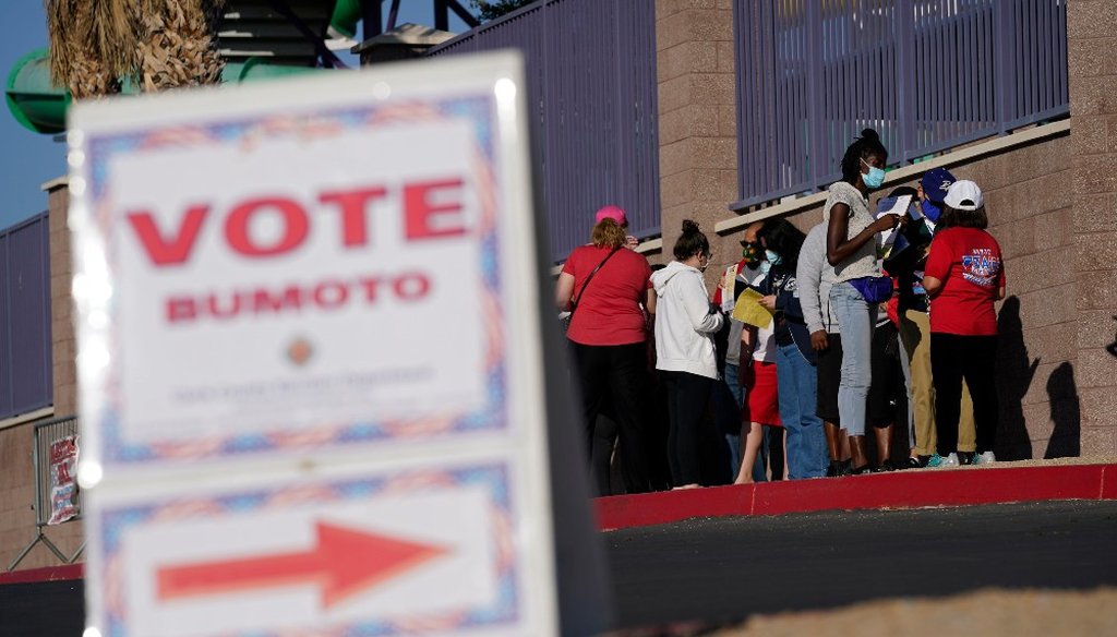 People wait in line to vote at a polling place on Election Day, Tuesday, Nov. 3, 2020, in Las Vegas, Nevada. (AP Photo/John Locher)