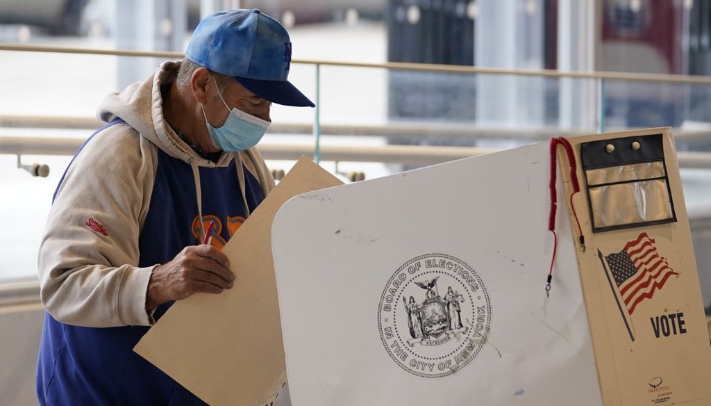 A voter studies his ballot before submitting it during early voting in 2020 at Columbia University's Forum in the West Harlem neighborhood of New York. (AP)