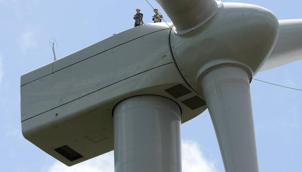 Workers stand on top of a land-based wind turbine in northeastern North Carolina. News & Observer photo.