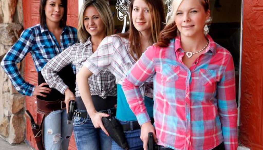 Waitresses Ashlee Saenz, Lauren Boebert, Jessie Spaulding, and Dusty Sheets pose with their sidearms in front of the Shooters Grill in Rifle, Colo., on June 23, 2014. The western Colorado restaurant encourages the open display of firearms.