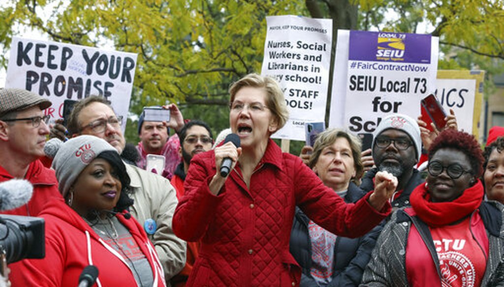 Democratic presidential candidate Elizabeth Warren with striking Chicago teachers. Her $800 billion public schools plan relies on funds from her 2% wealth tax. (AP Photo/Teresa Crawford)