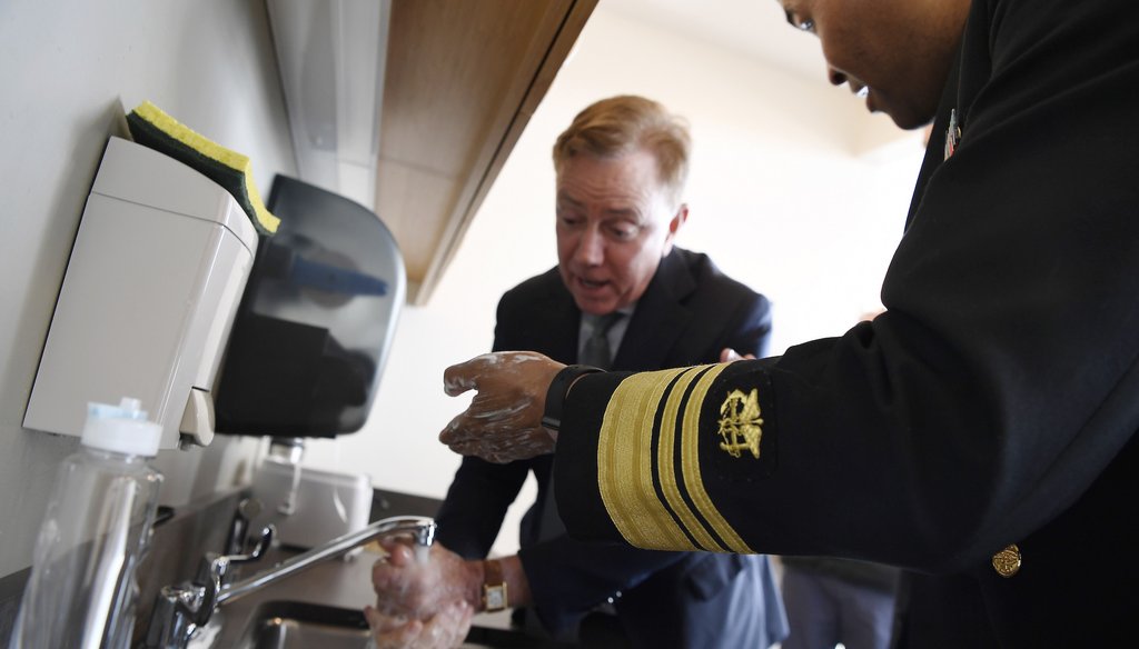 U.S. Surgeon General Vice Admiral Jerome M. Adams demonstrates how to wash hands with Connecticut Gov. Ned Lamont during a visit to the State Public Health Laboratory on March 2, 2020. (AP)