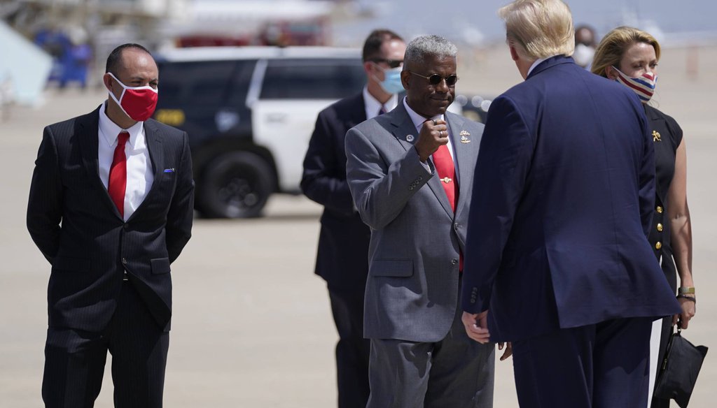 Allen West, chairman of the Republican Party of Texas, greets President Donald Trump as he arrives in Midland in July 2020. (AP Photo/Evan Vucci)