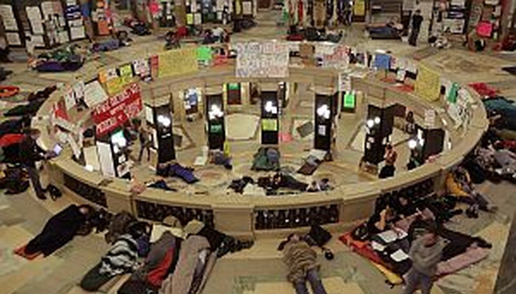 Protestors sleep in the rotunda of the Wisconsin state capitol on Thursday. 