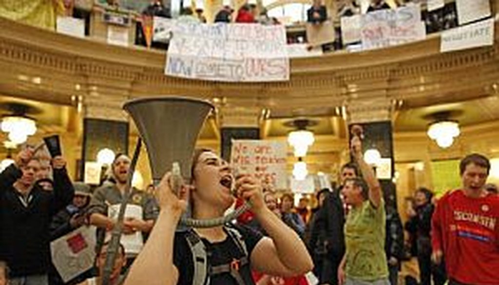 Protesters bang drums and shout slogans inside the state Capitol on Monday.