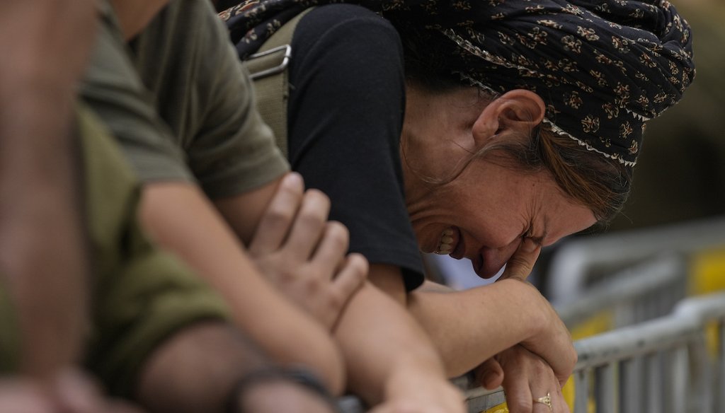 A woman cries during the funeral of Israeli Col. Roi Levy at the Mount Herzl cemetery in Jerusalem on Monday, Oct. 9, 2023. Col. Levy was killed after Hamas militants stormed from the blockaded Gaza Strip into nearby Israeli towns. (AP)