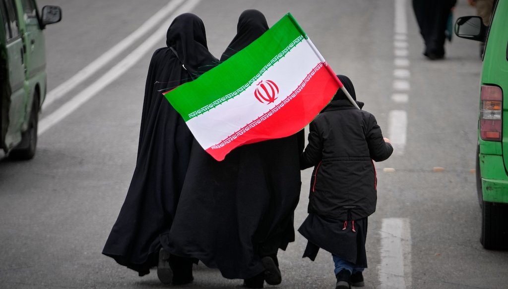 Two women and a child holding an Iranian flag walk toward the Imam Khomeini Grand Mosque to attend Friday prayers in Tehran, Iran, Friday, March 20, 2026. (AP)