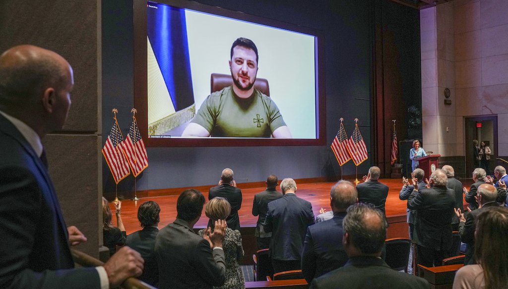 Members of Congress give Ukraine President Volodymyr Zelensky a standing ovation before he speaks in a virtual address to Congress in the U.S. Capitol in Washington, March 16, 2022.