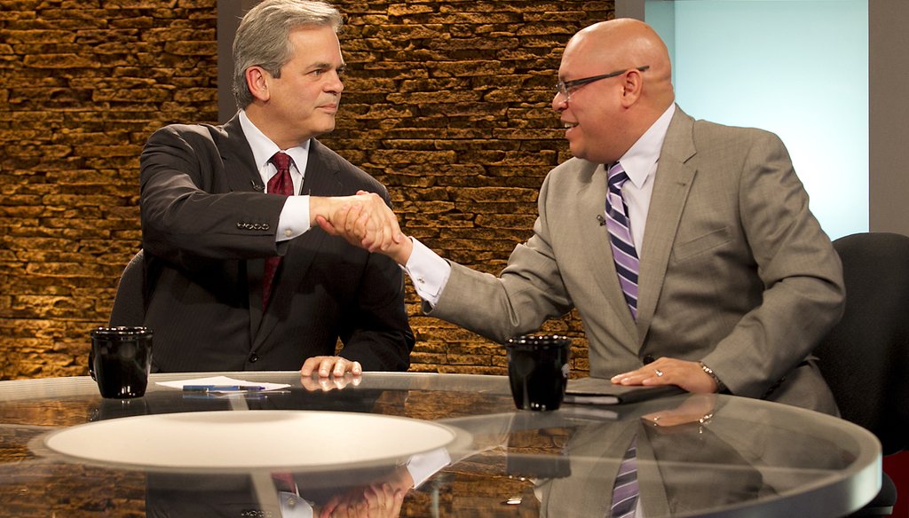 Mayoral aspirants Steve Adler and Mike Martinez shake at their Nov. 19, 2014, debate at TWC News.
