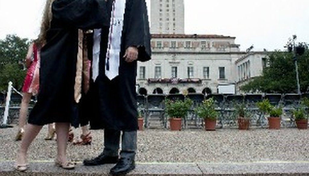Annelise Schuessler adjusts the cap and gown of fellow graduate Garrett Dee at the May commencement celebration at the University of Texas at Austin, an institution not listed among those with $10,000 degrees. (Andy Sharp, for Austin American-Statesman).