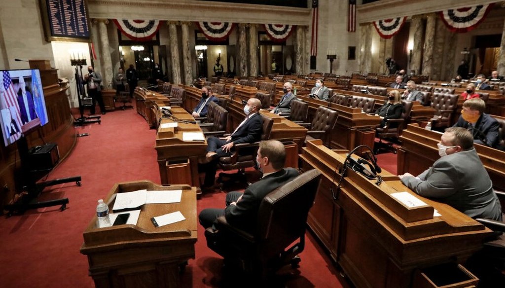Wisconsin Gov. Tony Evers delivers his State of the State address virtually as members of the Assembly watch from the Assembly Chambers at the Wisconsin State Capitol in Madison, Wis., Tuesday, Jan. 12, 2021. (Amber Arnold/Wisconsin State Journal via AP)