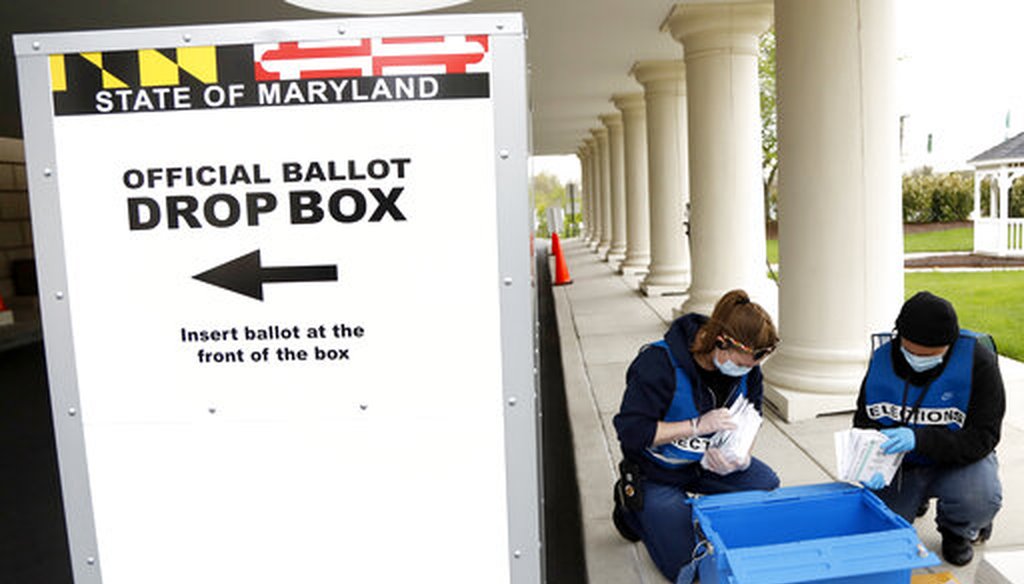 Election workers Jessica Fleming, left, and Amanda White count ballots while collecting them from a drop box outside a voting center during the 7th Congressional District special election, Tuesday, April 28, 2020, in Windsor Mill, Md. (AP)