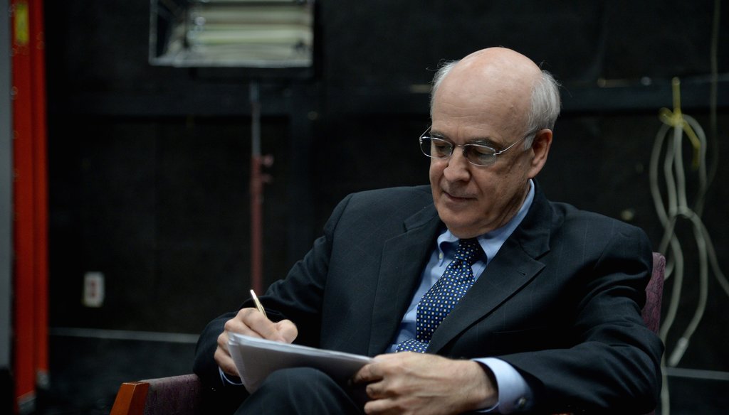 U.S. Senate candidate looks over notes at a political debate