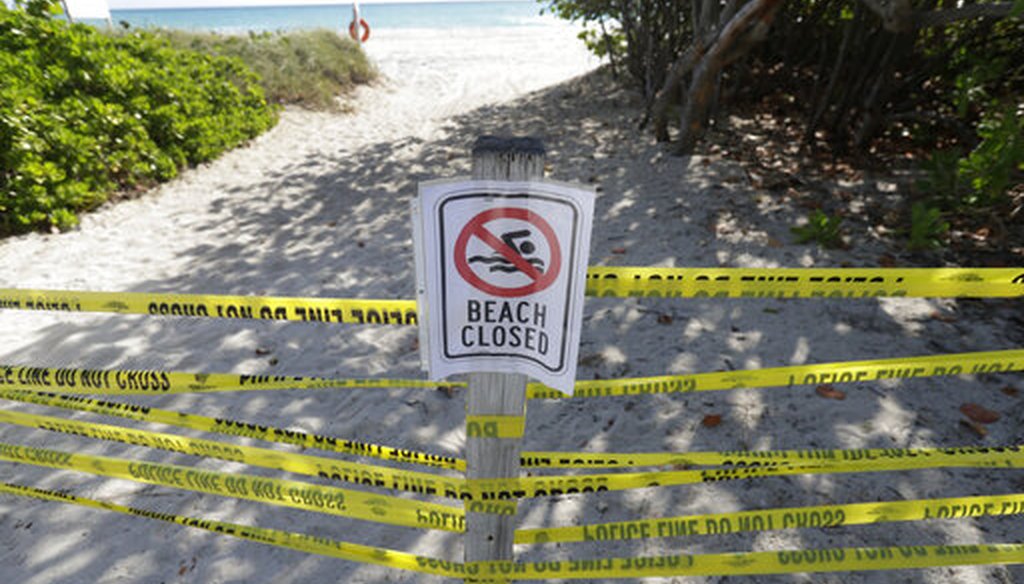 A beach entrance is cordoned off, Saturday, March 21, 2020, in Surfside, Fla. Miami-Dade County's mayor ordered all beaches, parks and "non-essential" commercial and retail businesses closed Thursday because of the new coronavirus pandemic. (AP)