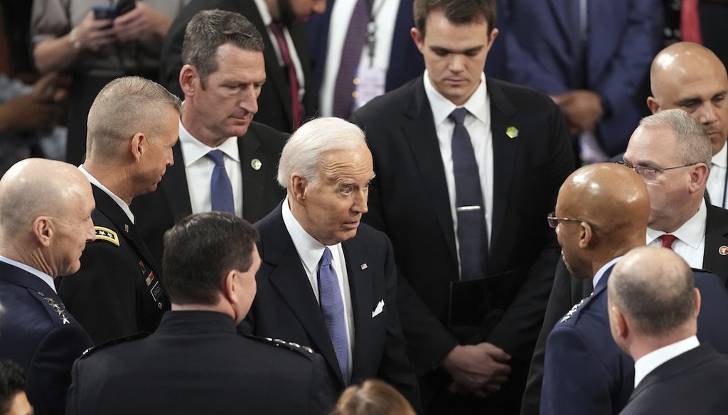President Joe Biden speaks to the Chairman of the Joint Chiefs of Staff Gen. CQ Brown on March 7, 2024, after the State of the Union address at the U.S. Capitol in Washington. (AP)
