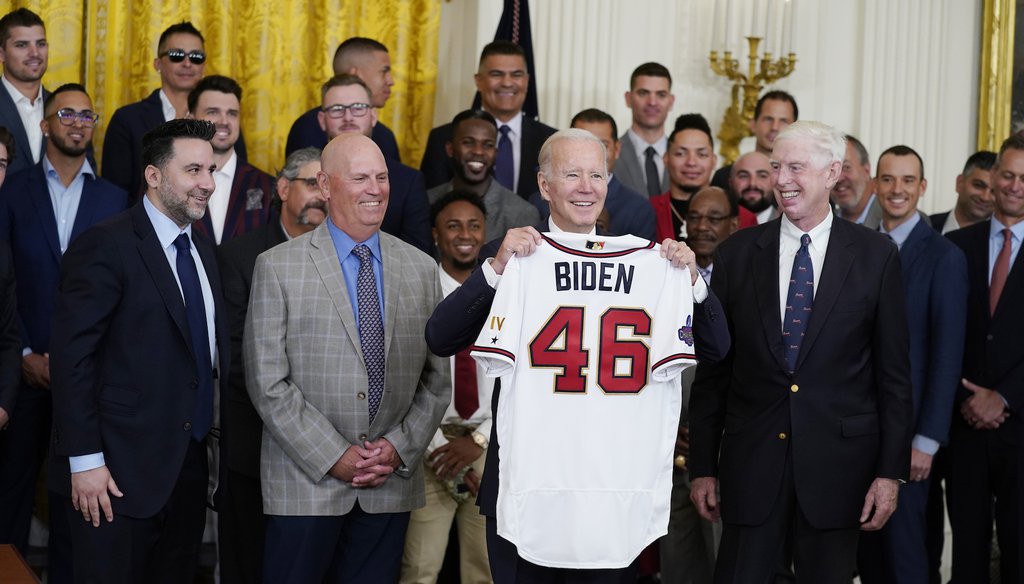 President Joe Biden holds an Atlanta Braves jersey during an event celebrating the team's 2021 World Series championship in the East Room of the White House on Sept. 26, 2022. (AP Photo/Evan Vucci)