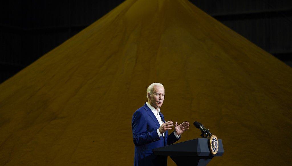 President Joe Biden speaks in front of a pile of distillers grains at POET Bioprocessing in Menlo, Iowa,  on April 12, 2022. (AP Photo/Carolyn Kaster)
