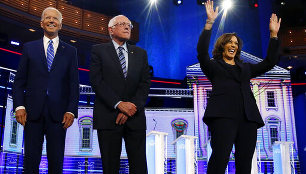 Democratic presidential candidates former vice president Joe Biden, left, Sen. Bernie Sanders, I-Vt., and Sen. Kamala Harris, D-Calif., right, stand on stage for the Democratic primary debate, Wednesday, June 27, 2019, in Miami (AP).