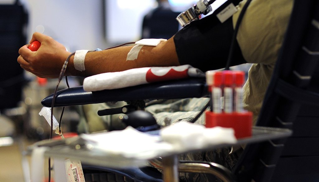 A member of the New Jersey Air National Guard squeezes an object while giving blood in Atlantic City, N.J., in 2015. (AP)
