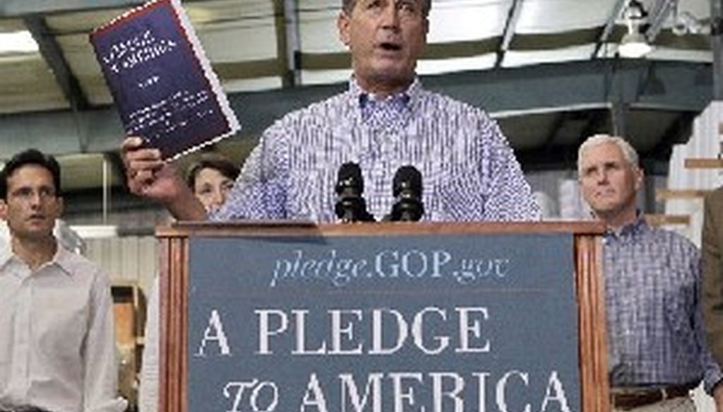 John Boehner of Ohio, who went on to become Speaker of the House, holds up a copy of the GOP agenda, "A Pledge to America," in 2010.