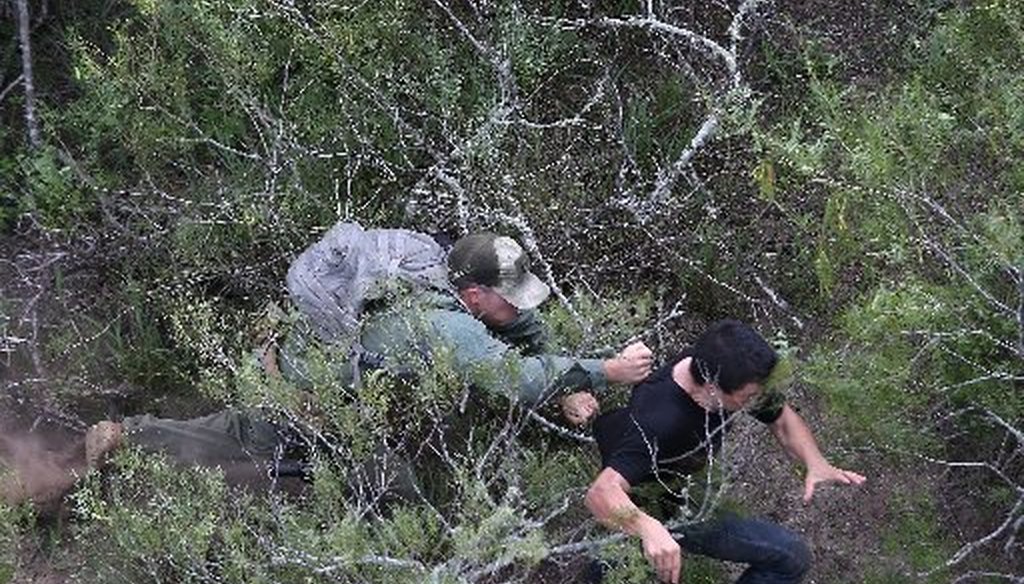 A U.S. Border Patrol agent pursues a suspected border crosser near Falfurrias, Texas, in 2014. We rated Pants on Fire a claim the U.S. alone doesn't use the military to secure its borders (Getty Images photograph).