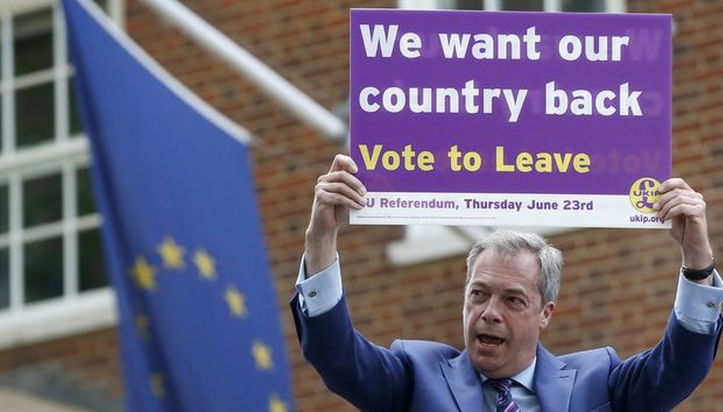 British politician and leader of the UKIP party Nigel Farage holds up a placard as he launches his party's campaign for Britain to leave the EU, outside the EU representative office in London. (AP)