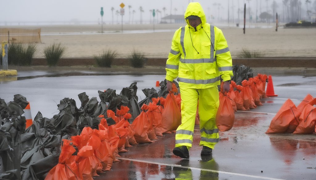 A Long Beach Fire Department Oceanside lifeguard loads sandbags at the Peninsula in Long Beach, Calif.,  Feb. 19, 2024, during the latest in a series of wet winter storms in the state. (AP)