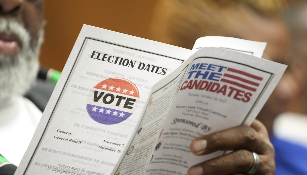 A candidates forum attendee reviews the event program Oct. 26, 2023, in Vicksburg, Miss. (AP)