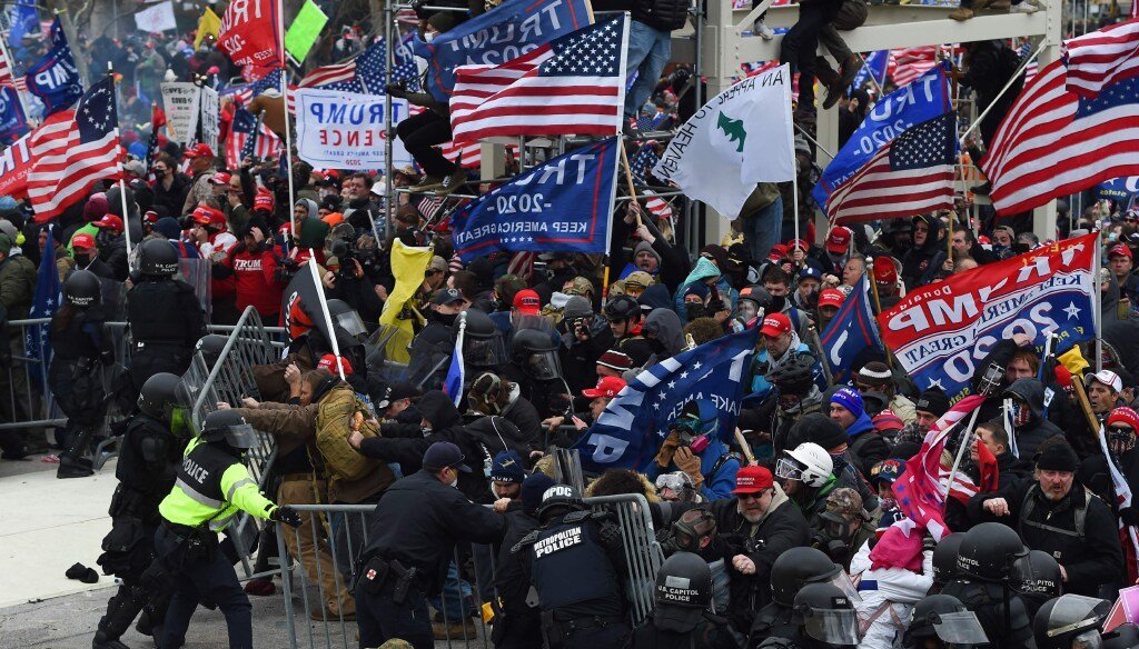 Trump supporters clash with police and security forces outside the U.S. Capitol in Washington D.C on Jan. 6, 2021. (Photo by ROBERTO SCHMIDT / AFP)