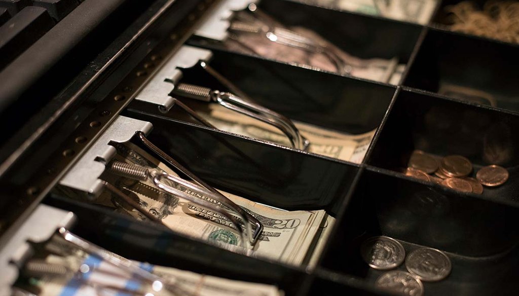 A cash register till shows dollar bills in a register at a business in Eagle, Colo. (AP)