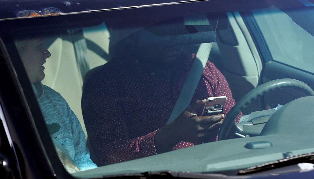 This April 24, 2019, photo shows one of several distracted drivers using cellphones during an enforcement effort in Eagan, Minn. (Anthony Souffle/Star Tribune via AP)