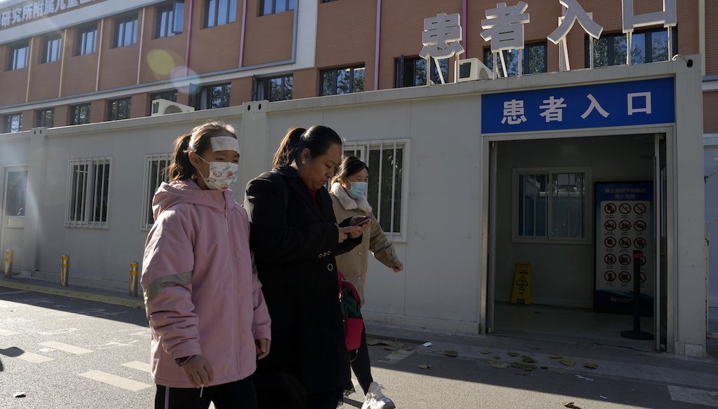Visitors pass by a children's hospital in Beijing, Nov. 24, 2023. Chinese officials say they did not detect any "unusual or novel diseases" related to a spike in respiratory illnesses and clusters of pneumonia in children. (AP)