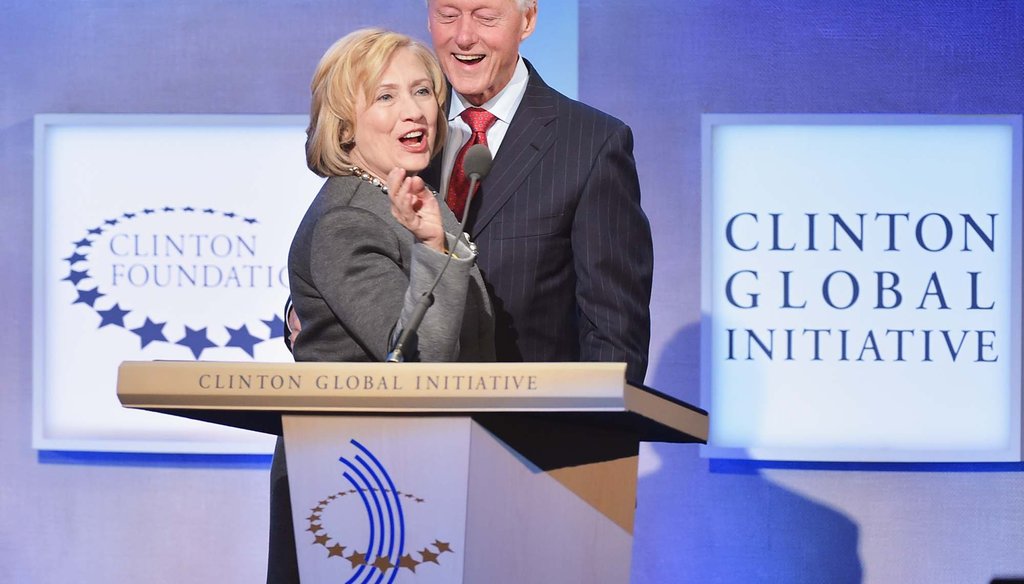 In this Sept. 22, 2014 file photo, former Secretary of State Hillary Clinton and former President Bill Clinton address the audience at the annual Clinton Global Initiative meeting in New York City. (Photo by Michael Loccisano/Getty Images)