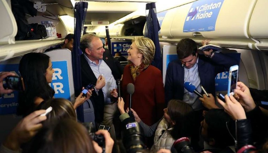 Former Secretary of State Hillary Clinton and her running mate, U.S. Sen. Tim Kaine, D-Va., answer questions aboard her plane at Pittsburgh International Airport on Oct. 22, 2016. (Getty Images)