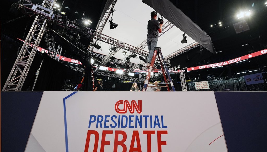 People converse during setup in the spin room for the presidential debate between President Joe Biden and Republican presidential candidate former President Donald Trump in Atlanta. (AP)