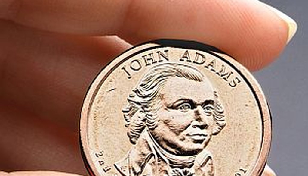 Congressional auditors say doing away with dollar bills entirely and replacing them with dollar coins, like this President John Adams presidential $1 coin, could save taxpayers some $4.4 billion over the next 30 years. (AP Photo/US Mint, File)