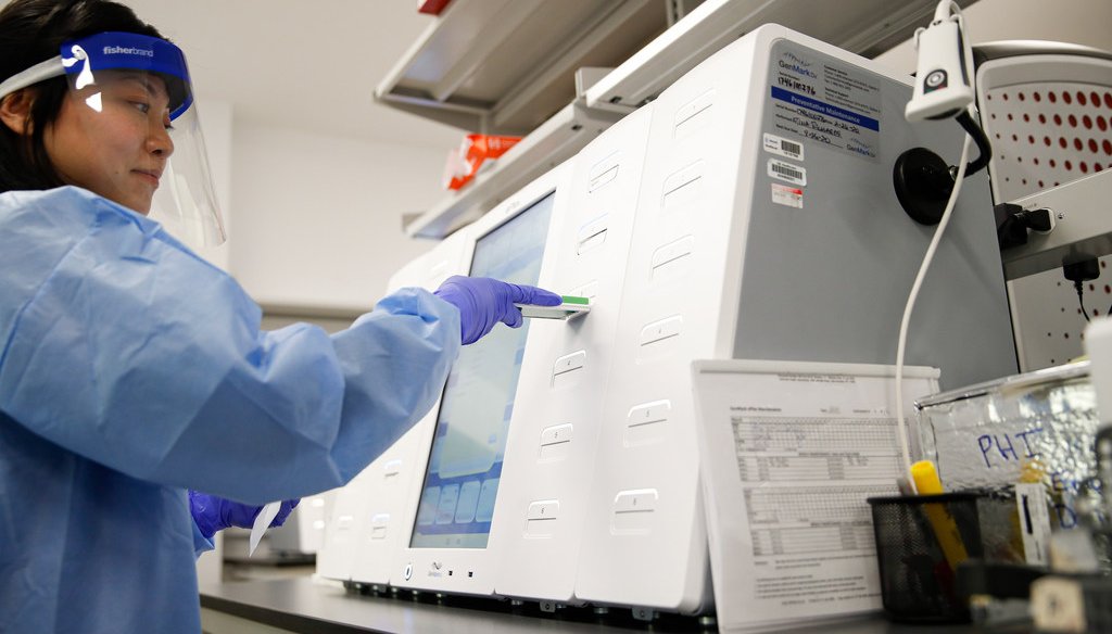 A laboratory technician prepares COVID-19 patient samples for semi-automatic testing at Northwell Health Labs, Wednesday, March 11, 2020 (AP photo/John Minchillo)