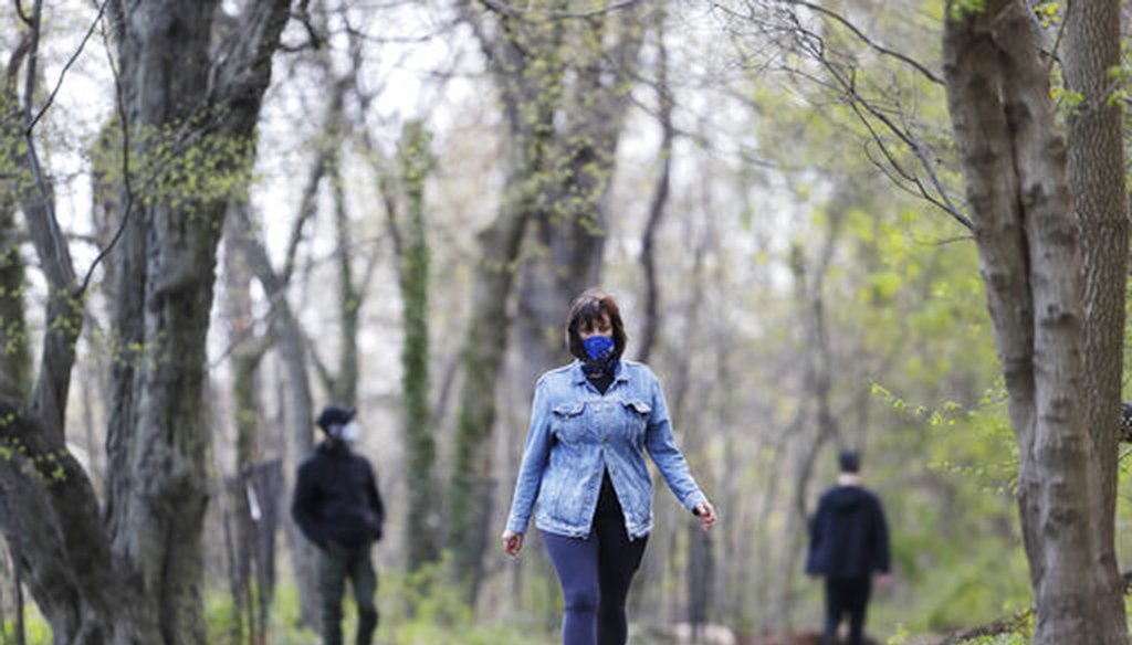 Alfina Schicker takes a solitary walk through the woods in Brooklyn's Prospect Park, Tuesday, April 14, 2020 during the coronavirus pandemic in New York. (AP)
