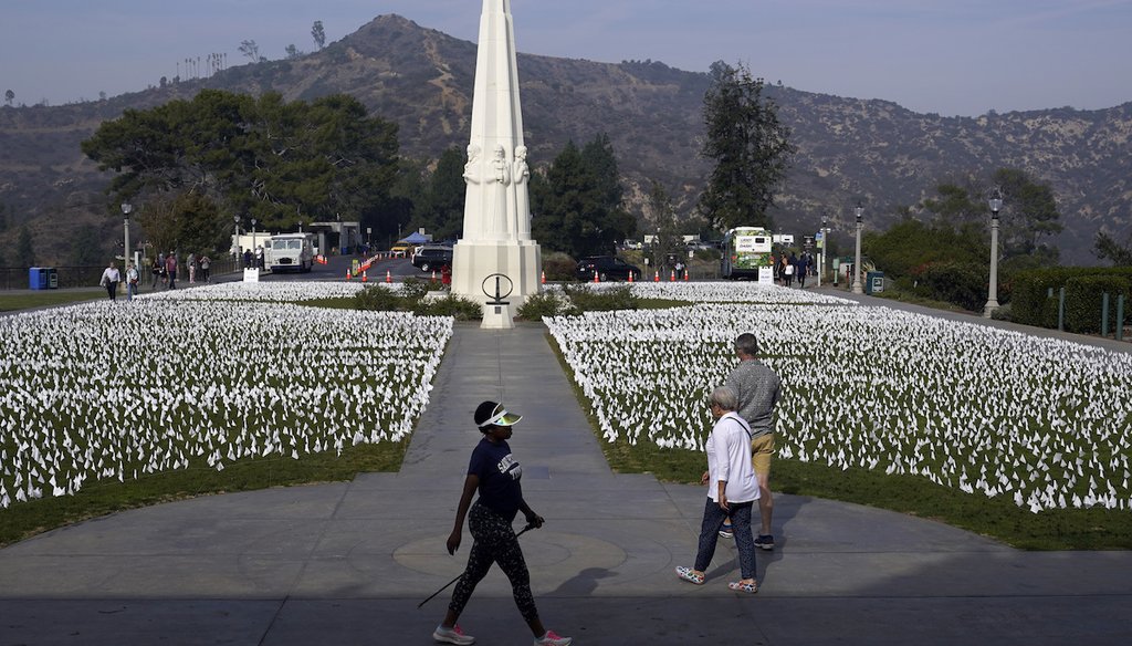 Visitors walk around a memorial for victims of COVID-19 at the Griffith Observatory, Nov. 19, 2021, in Los Angeles. (AP)