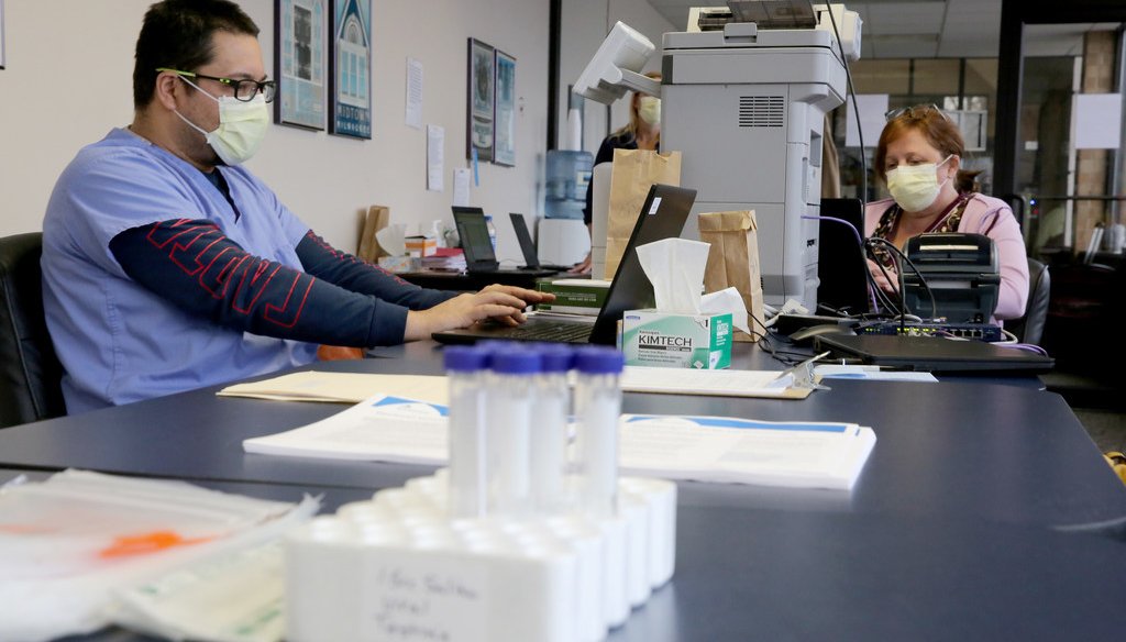 A nurse and assistant enter testing information at a COVID-19 drive through testing location in Milwaukee on Monday, April 27, 2020. (Photo by Mike De Sisti/Milwaukee Journal Sentinel)